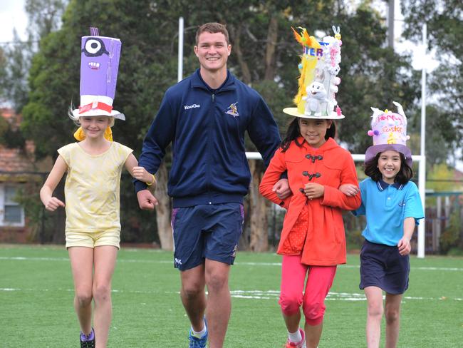 Eva Mooney-Smith, Kinda Einsiedel, Joe Stimson from Melbourne Storm and Carmen Guajardo take part in fancy hat day at Sunshine Harvester Primary School. Picture: Andrew Henshaw