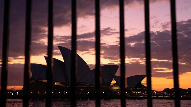 he sun rises behind the Sydney Opera House. Picture: Getty Images