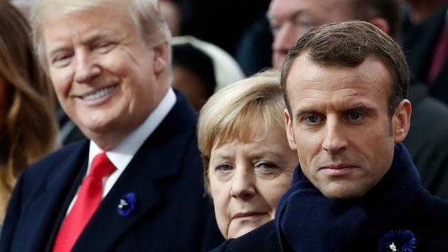 Donald Trump (L), Angela Merkel (C) and Emmanuel Macron attend a ceremony at the Arc de Triomphe in Paris. Picture: AFP