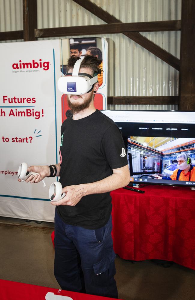 Lachlan Reid using a VR workplace simulation at the AimBig stall at the expo. Picture: Kevin Farmer