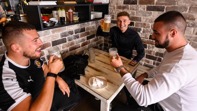 A group of men drinking beer at 'Soy Restaurant' in Bondi Beach, Sydney, Friday, May 15, 2020. Pubs, clubs, cafes, restaurants, and places of worship are now able to welcome up to 10 people inside their doors under an easing of NSW's COVID-19 restrictions. (AAP Image/James Gourley) NO ARCHIVING