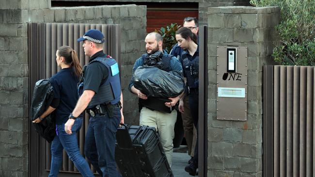 Police leaving John Ibrahim's house in Dover Heights as part of the massive operation Picture: Richard Dobson