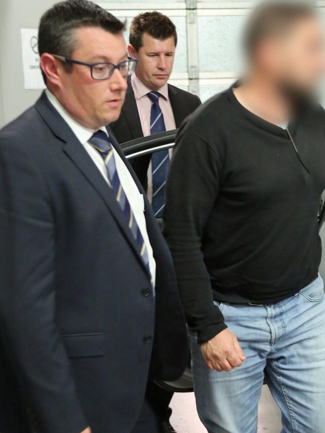 Detective Sergeant Luke Scott (glasses) makes an arrest as part of Brayden Dillon murder investigation.