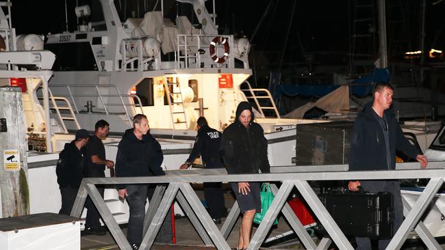 After a long day at sea, Port Stephens Water Police and police divers return to Nelson Bay Marina on Wednesday. Picture: Peter Lorimer.