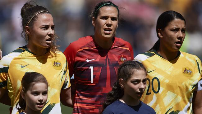 Matildas Jenna McCormick, Lydia Williams and Sam Kerr stand for the anthem before the international friendly match against Chile at Bankwest Stadium in Sydney on November 9. Picture: Brett Hemmings/Getty Images