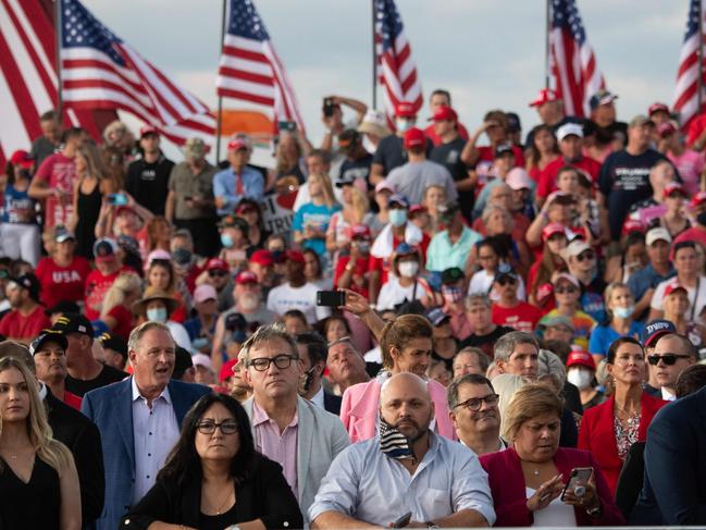 TOPSHOT - Supporters of US President Donald Trump attend a Make America Great Again rally as he campaigns at Orlando Sanford International Airport in Sanford, Florida, October 12, 2020. (Photo by SAUL LOEB / AFP)