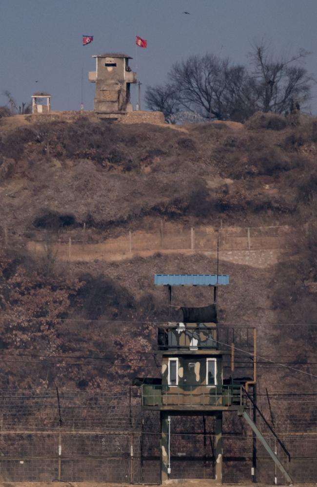 Close quarters: North Korean (top) and South Korean (bottom) military guard posts are seen near the Demilitarised Zone (DMZ) separating North and South Korea. Picture: AFP/Ed Jones