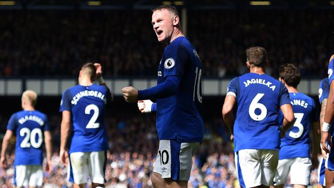 Everton's English striker Wayne Rooney (C) celebrates.