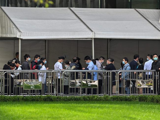 People queue up to be tested as a measure against the Covid-19 coronavirus at the Jing An Kerry Centre in Shanghai. Picture: AFP.