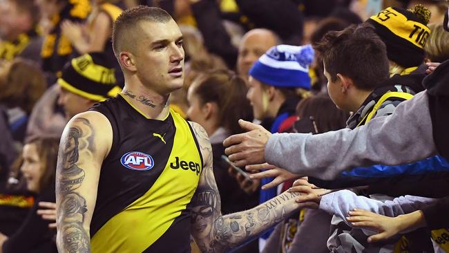 MELBOURNE, AUSTRALIA — JUNE 03: Dustin Martin of the Tigers high fives fans after winning the round 11 AFL match between the North Melbourne Kangaroos and the Richmond Tigers at Etihad Stadium on June 3, 2017 in Melbourne, Australia. (Photo by Quinn Rooney/Getty Images)