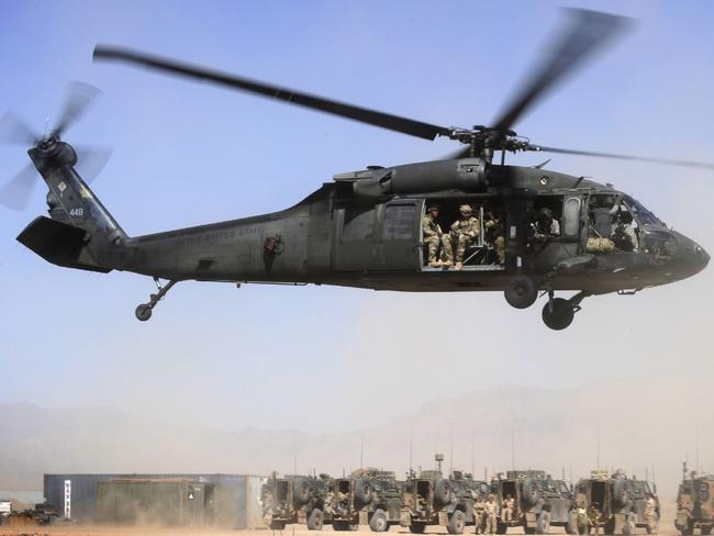 Afghan Officers from the Provincial Police Response Company and Australian Special Operations Task Group Soldiers lift off in a UH-60 Blackhawk helicopter. Picture: Corporal Raymond Vance