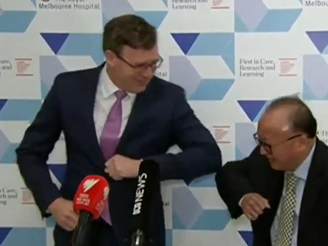 Alan Tudge bumps elbows with Sunny Duong at the cheque presentation in June. Picture: 9NEWS Melb