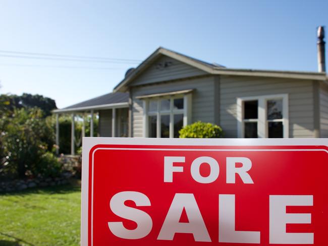 A For Sale Sign Outside a House.