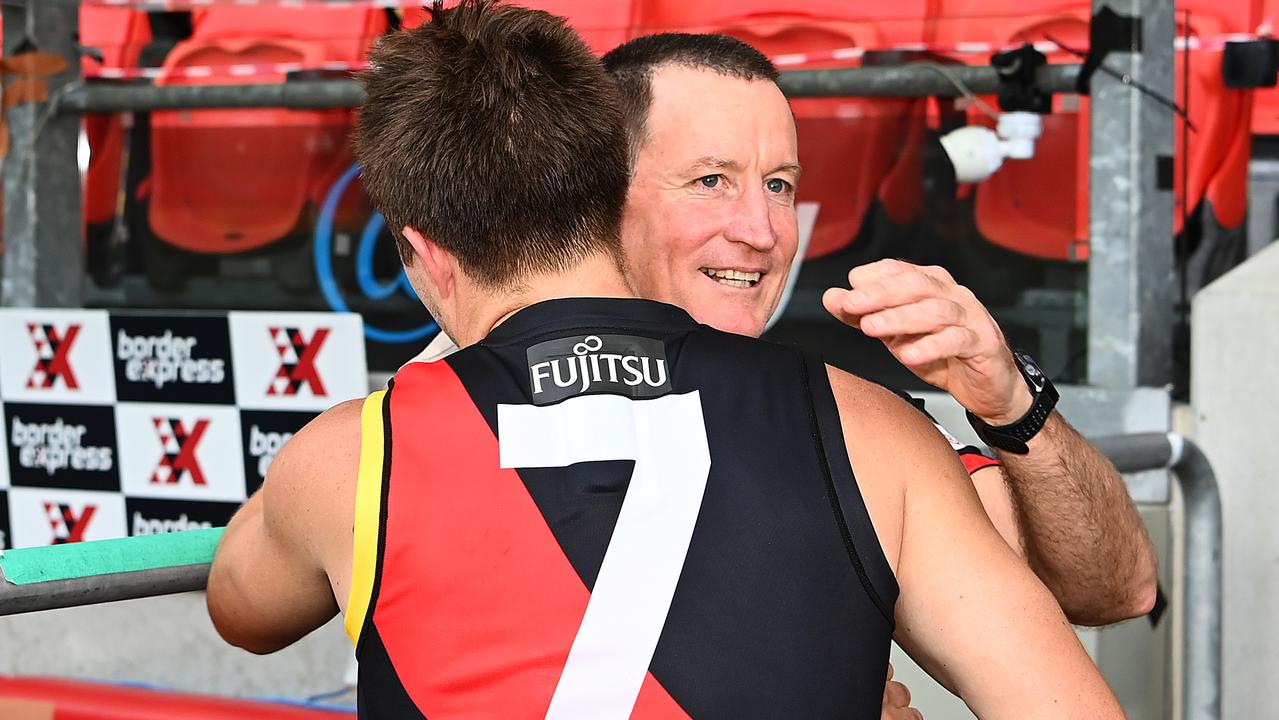 Zach Merrett embraces John Worsfold after his last game as Essendon coach.