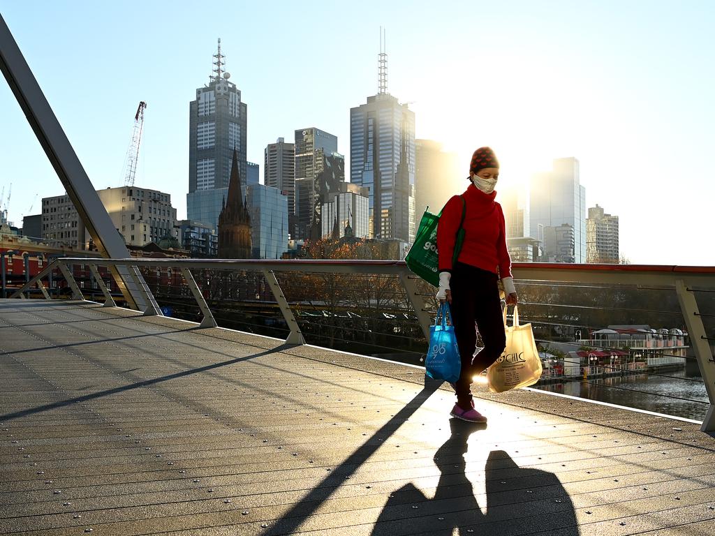 A pedestrian walks along Southgate Bridge during lockdown. Picture: Quinn Rooney/Getty Images