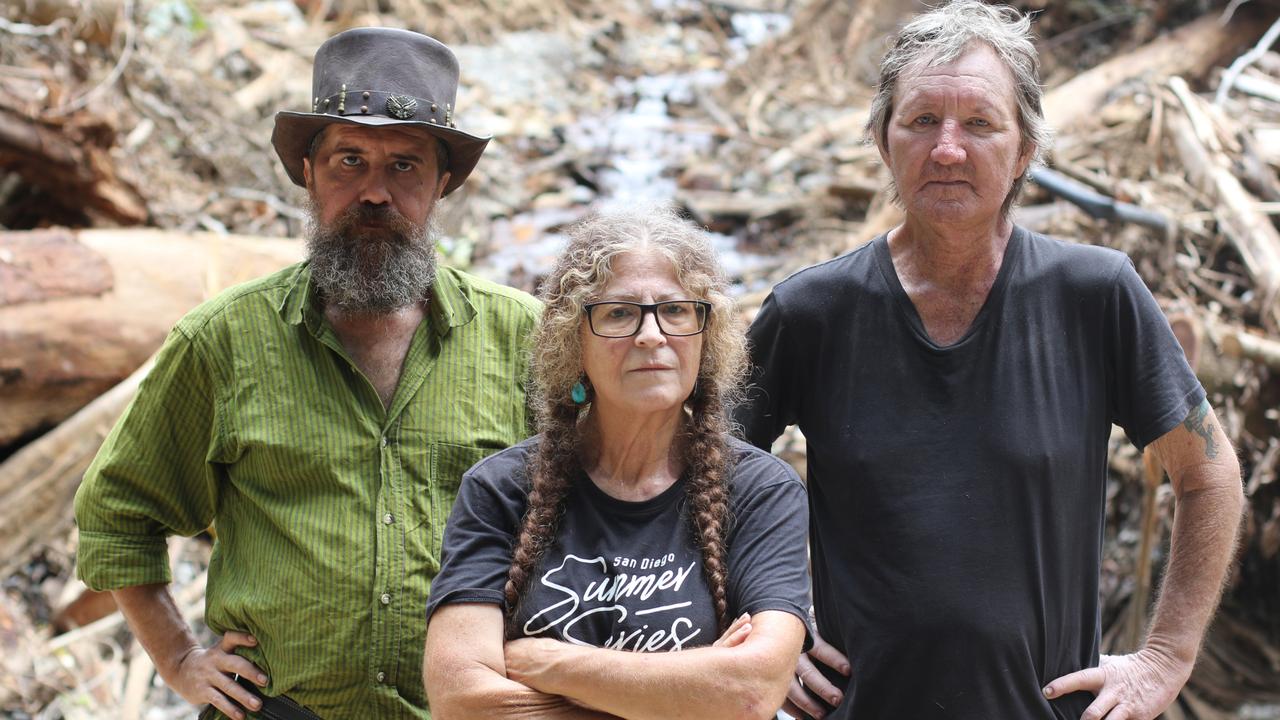 Cape Tribulation residents Rastah Rusch, Zoe Photellis and Stephen Maloney are frustrated with the lack of disaster recovery efforts to help their community following ex-Tropical Cyclone Jasper. Mr Maloney and Mr Rusch, who both have significant health conditions, still cannot leave the community as they do not have access to a four-wheel drive.