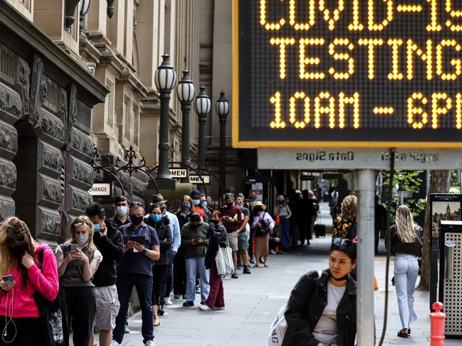 MELBOURNE, AUSTRALIA - DECEMBER 22: People queue outside Melbourne Town Hall Covid-19 testing centre on December 22, 2021 in Melbourne, Australia. Demand at COVID-19 testing centres across Melbourne has increased in the lead-up to Christmas as new coronavirus cases continue to emerge. (Photo by Diego Fedele/Getty Images) *** BESTPIX ***