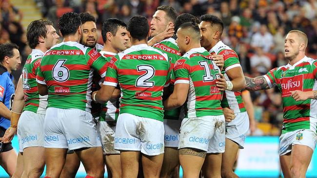 Bryson Goodwin of the Rabbitohs is congratulated by teammates after scoring a try.
