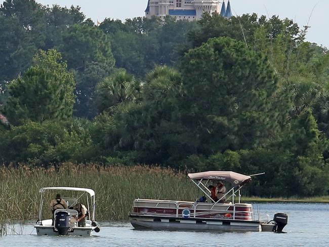 In the shadow of Disney’s Magic Kingdom, authorities search for the body of the young boy taken by an alligator. Picture: Red Huber/Orlando Sentinel