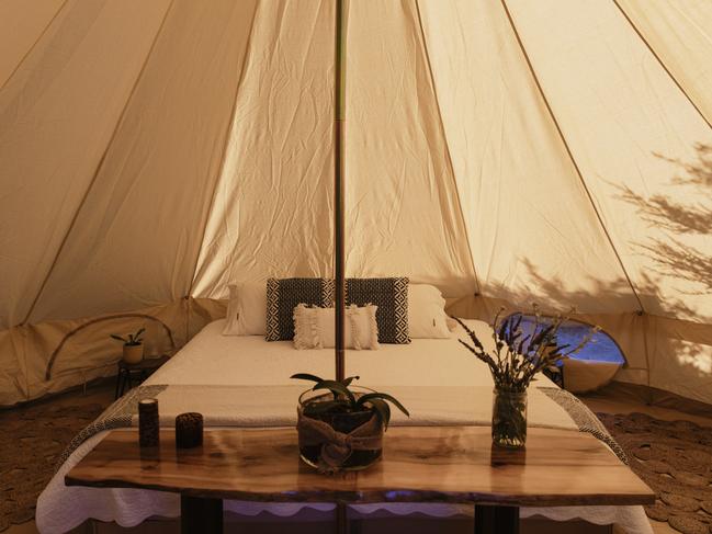 Inside one of the bell tents complete with comfy kingsize bed and plush furnishings. Picture: Supplied