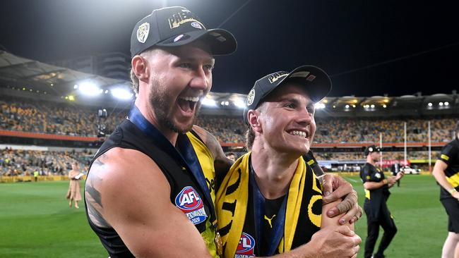 BRISBANE, AUSTRALIA - OCTOBER 24: Nathan Broad and Liam Baker celebrate victory after the 2020 AFL Grand Final match between the Richmond Tigers and the Geelong Cats at The Gabba on October 24, 2020 in Brisbane, Australia. (Photo by Bradley Kanaris/AFL Photos/via Getty Images)