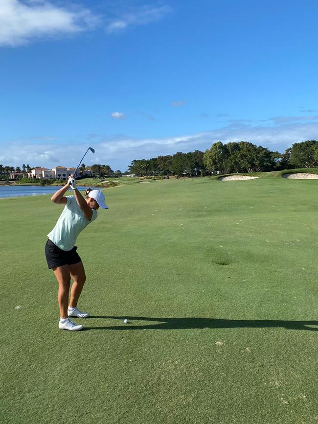 Ash Barty gets in some golf at Hope Island on Thursday.