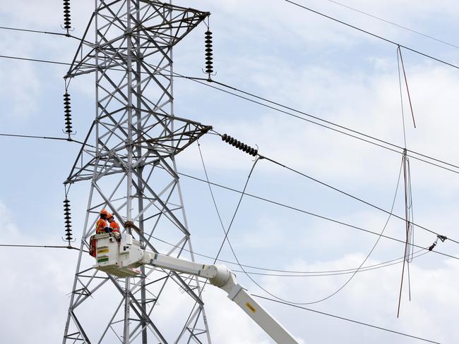 Workers from Endeavour Energy repairing a high-voltage power line that fell over multiple streets and properties around Aquilina Drive at Plumpton. Picture: Jonathan Ng