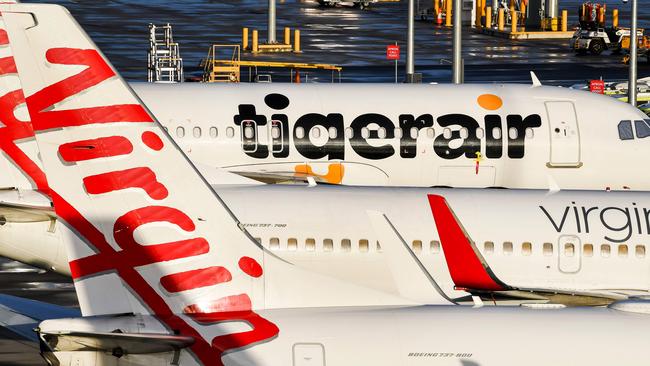 Planes from Australian airlines TigerAir and Virgin sit idle on the tarmac. (Photo by William West / AFP)