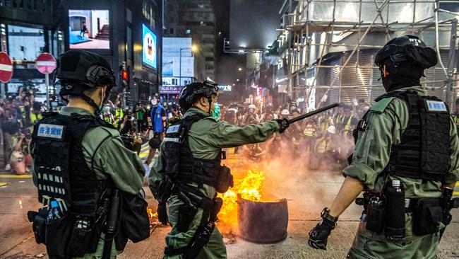 Hong Kong riot police form a road block against protesters in the city’s Mongkok district on Wednesday night. Picture: AFP