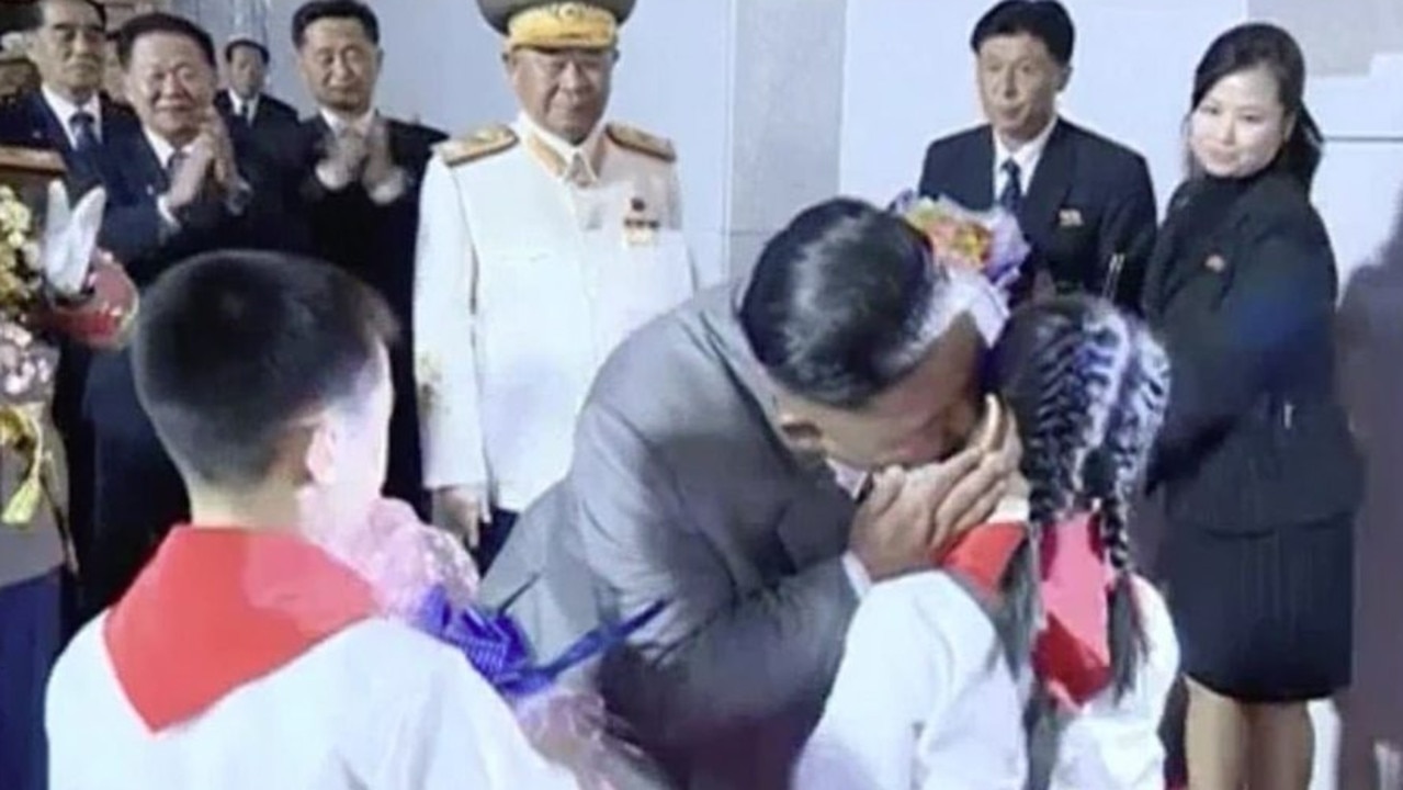 Kim Jong-un kisses a young North Korean girl.