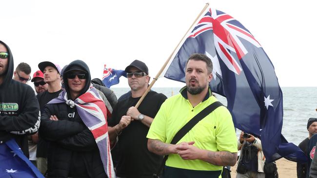 Far-right wing activist Neil Erikson (yellow shirt) was seen at the rally in St Kilda at the weekend. Picture: AAP/David Crosling