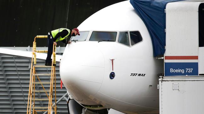 A worker inspects a Boeing 737 MAX airliner at Renton Airport adjacent to the Boeing Renton Factory in Renton, Washington. Picture: AFP