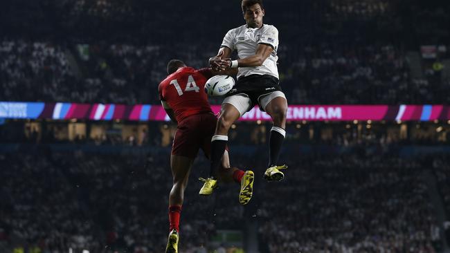 England's winger Anthony Watson (L) and Fiji's fly-half Ben Volavola jump to catch a cross-field kick during a Pool A match of the 2015 Rugby World Cup between England and Fiji at Twickenham stadium in south west London on September 18, 2015. AFP PHOTO / ADRIAN DENNIS RESTRICTED TO EDITORIAL USE, NO USE IN LIVE MATCH TRACKING SERVICES, TO BE USED AS NON-SEQUENTIAL STILLS