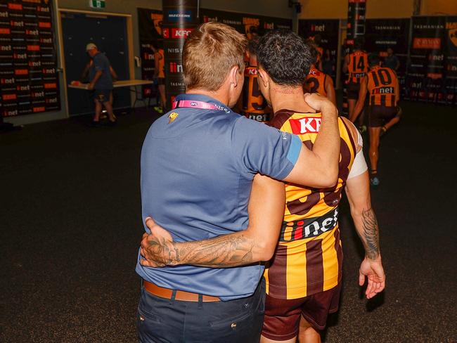 LAUNCESTON, AUSTRALIA - APRIL 01: Sam Mitchell, Senior Coach of the Hawks and Tyler Brockman of the Hawks put their arms around each other after leaving the field during the 2023 AFL Round 03 match between the Hawthorn Hawks and the North Melbourne Kangaroos at UTAS Stadium on April 1, 2023 in Launceston, Australia. (Photo by Dylan Burns/AFL Photos via Getty Images)