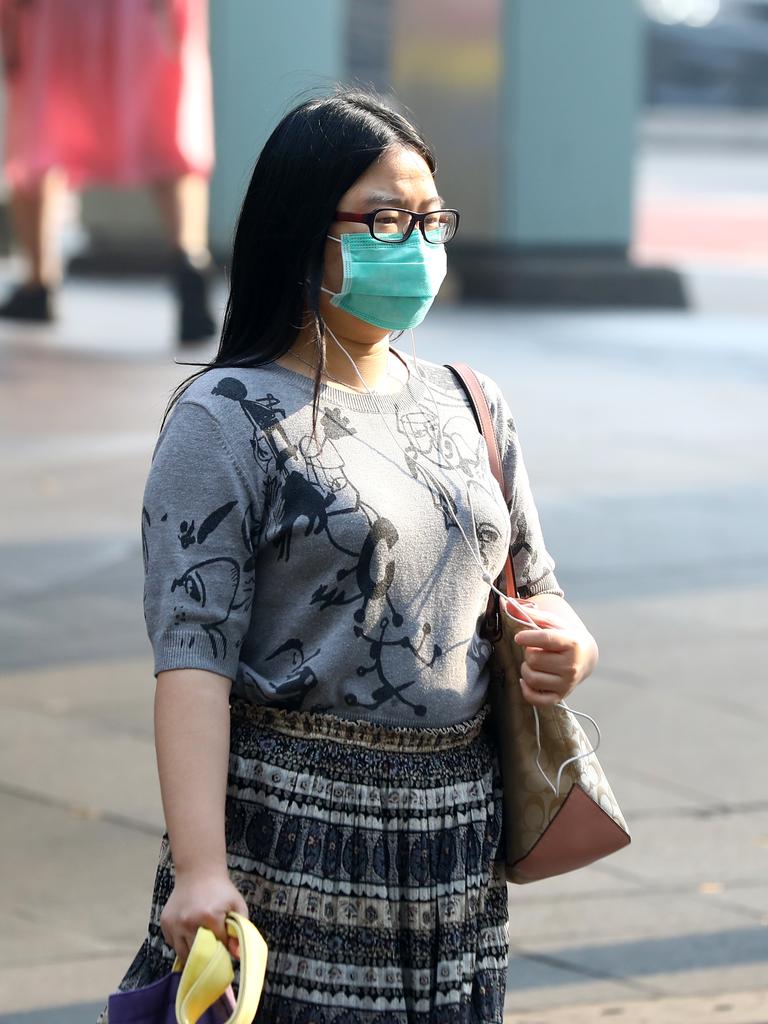 As smoke from bushfires engulfs Sydney, morning commuters are pictured wearing face masks as they make their way to work. Picture: MATRIX