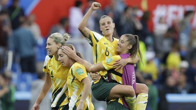 Player of the match Chloe Logarzo, top, celebrates with teammates after Australia defeated Brazil in Montpellier. Picture: AAP