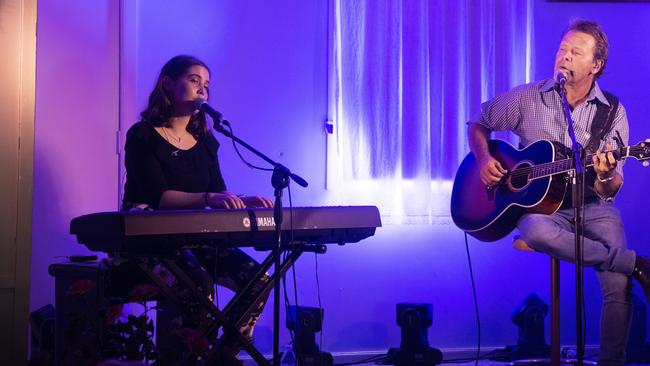 Troy Cassar-Daley sings with his daughter Jem at the Coutts Crossing hall