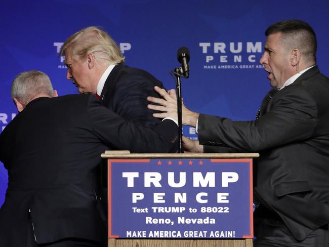 Secret Service agents rush Donald Trump off the stage at a campaign rally in Reno, Nevada. Picture: AP/John Locher