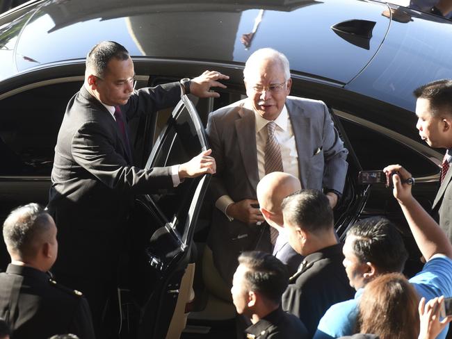 Former Malaysian Prime Minister Najib Razak gets off a car upon arrival at Kuala Lumpur High Court in Kuala Lumpur, Malaysia, Thursday, Oct. 25, 2018. Najib, along with two former high-ranking officials, faces fresh charges of criminal breach of trust involving the use of government funds. (AP Photo/Yam G-Jun)