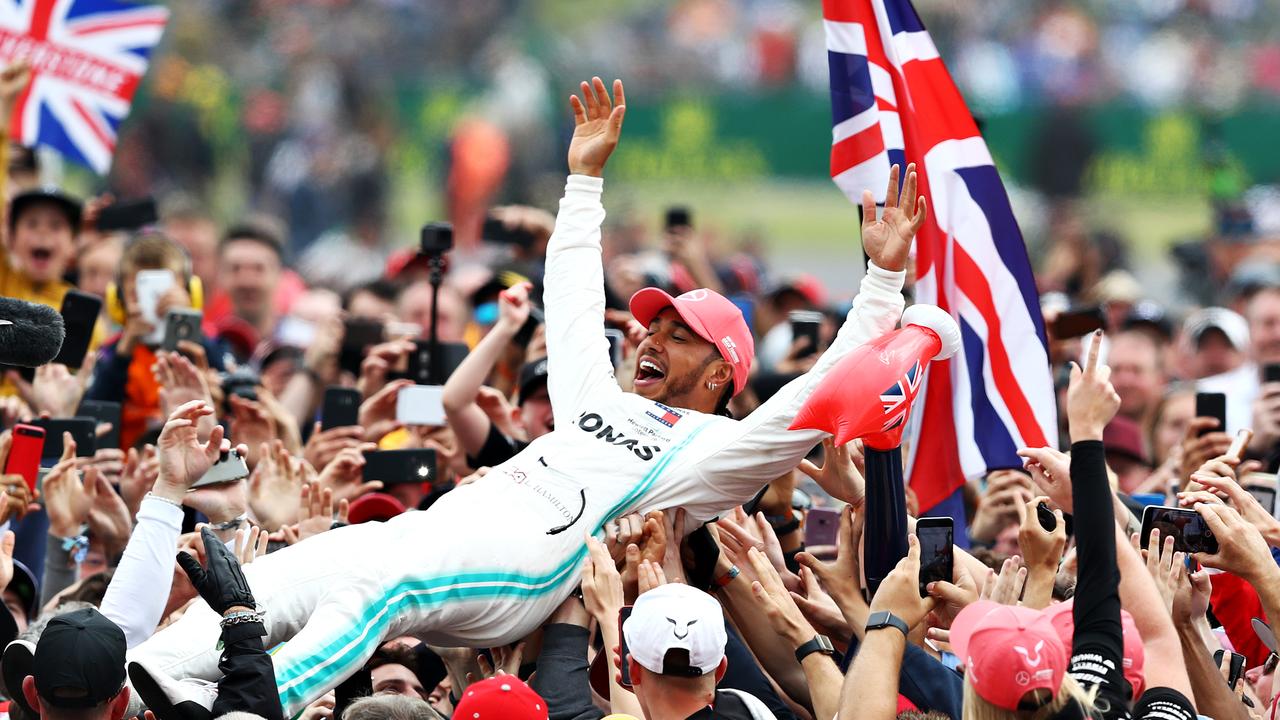 Race winner Lewis Hamilton celebrates.