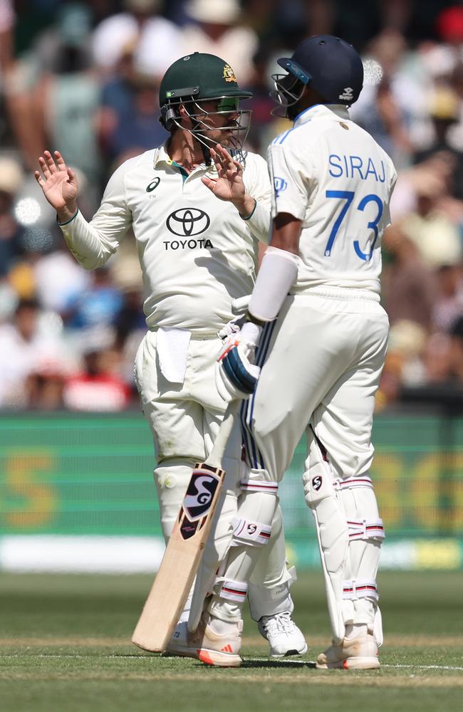 Travis Head talks with Mohammed Siraj in the middle of Adelaide Oval. Picture: Paul Kane/Getty Images.