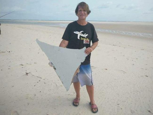 US MH370 blogger/investigator Blaine Gibson with the piece of suspected MH370 debris he found on a sandbank in the Mozambique Channel last weekend. Picture: Blaine Alan Gibson