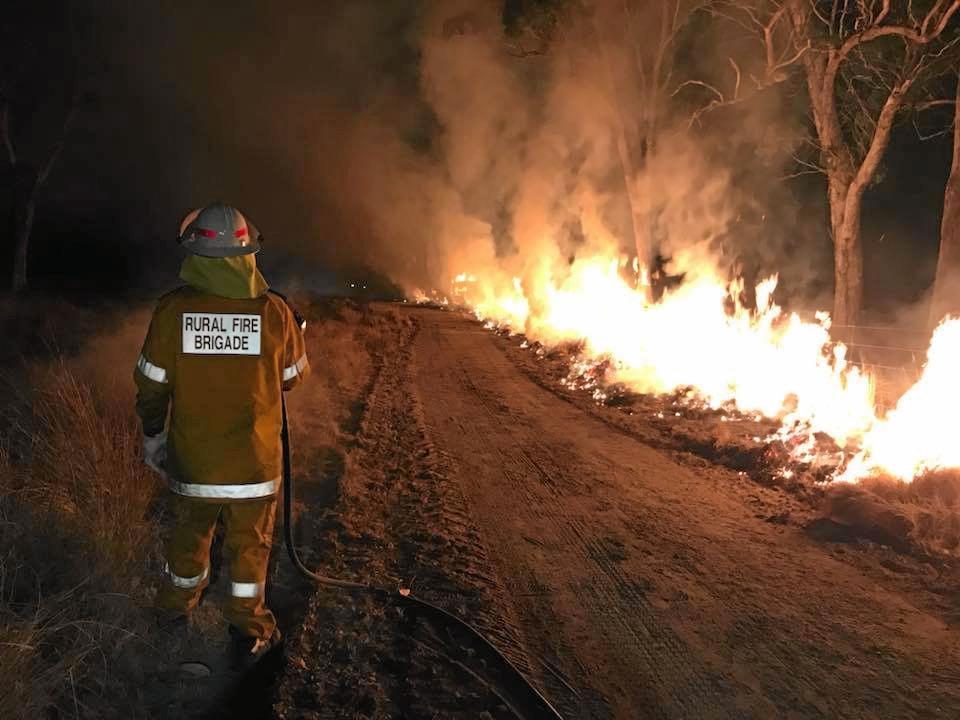 BURNING: Sixteen crews from the rural and urban fire brigades worked into Sunday night and throughout Monday morning to keep Ballandean residents safe from the bush fire. Picture: Sally Rowen