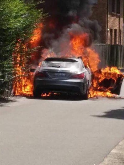 A car was pictured set alight in the wake of Hawi’s daylight execution. Picture: Claude Nunes