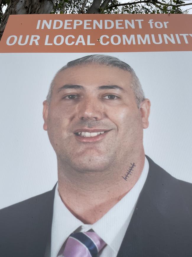 Independent Steve Christou's poster is defaced at the Granville Public School booth.