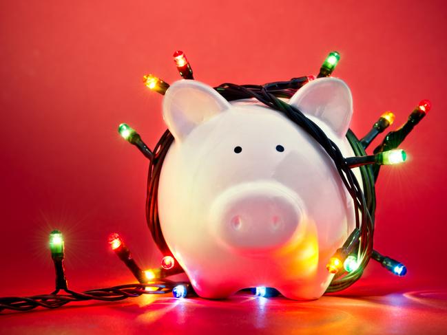 Piggy bank wrapped in Christmas string lights; money generic