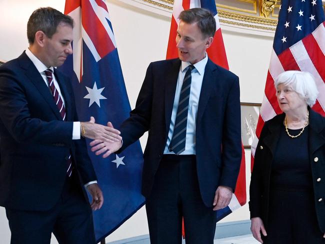 (L-R) Australia's Treasurer Jim Chalmers shakes hands with Britain's Chancellor of the Exchequer Jeremy Hunt as US Treasury Secretary Janet Yellen looks on following a meeting of the Five Eyes Finance Ministers at the Treasury Department in Washington, DC, on April 18, 2024. (Photo by OLIVIER DOULIERY / AFP)
