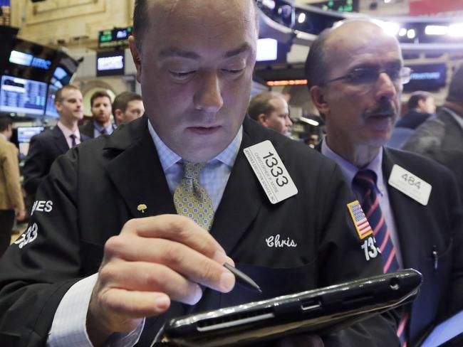 Trader Christopher Morie, left, works on the floor of the New York Stock Exchange, Friday, Nov. 13, 2015. Sharp declines in retailers were dragging the stock market lower in early trading as investors worry that holiday sales could slump. (AP Photo/Richard Drew)