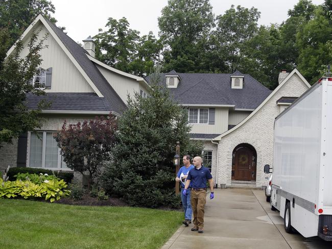 Federal authorities talk outside of the home of Subway restaurant spokesman Jared Fogle, Tuesday, July 7, 2015, in Zionsville, Indiana. Picture: Michael Conroy