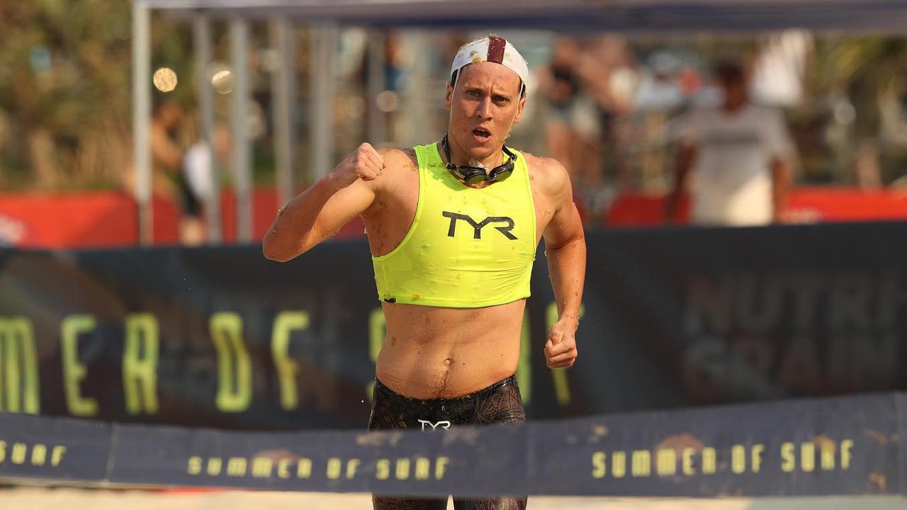 Noosa’s Nick Sloman fist pumps after winning the Open Run Swim Run, Open Male Surf Race.